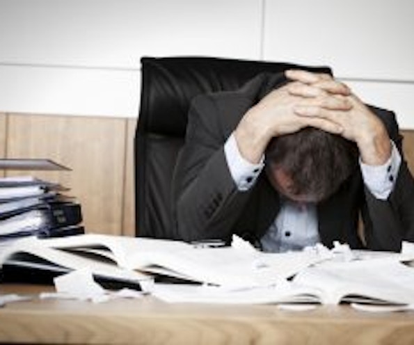 Automated Data Collection in Modern Manufacturing Man frustrated by manual data entry without automated data collection